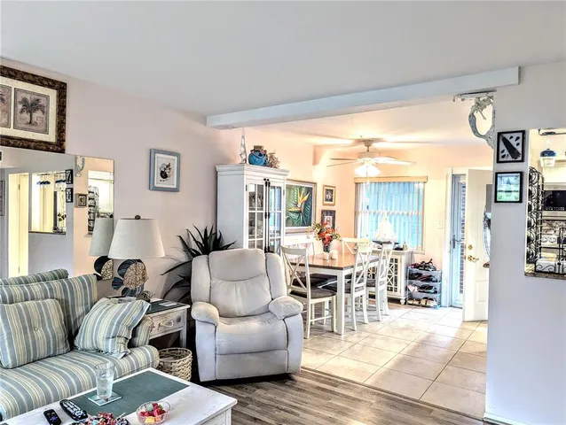 a living room with furniture and large windows