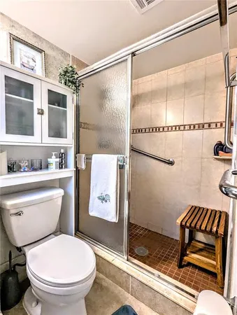 a white toilet sitting next to a bathroom sink