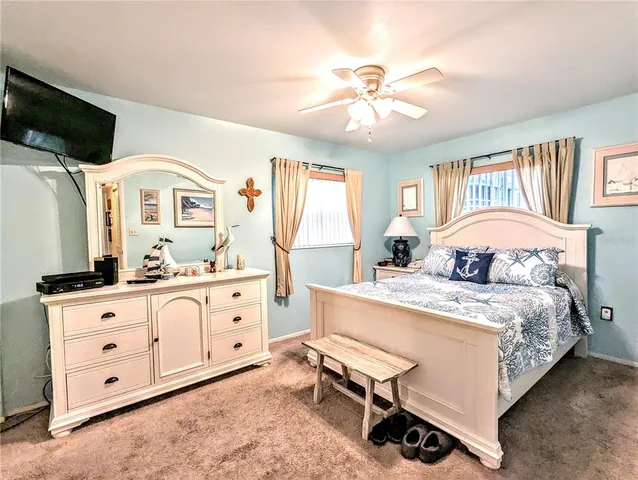 a spacious bedroom with a bed and a chandelier