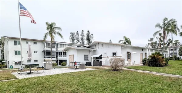 a view of a house with backyard and sitting area