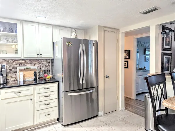 a kitchen with stainless steel appliances a refrigerator sink and cabinets