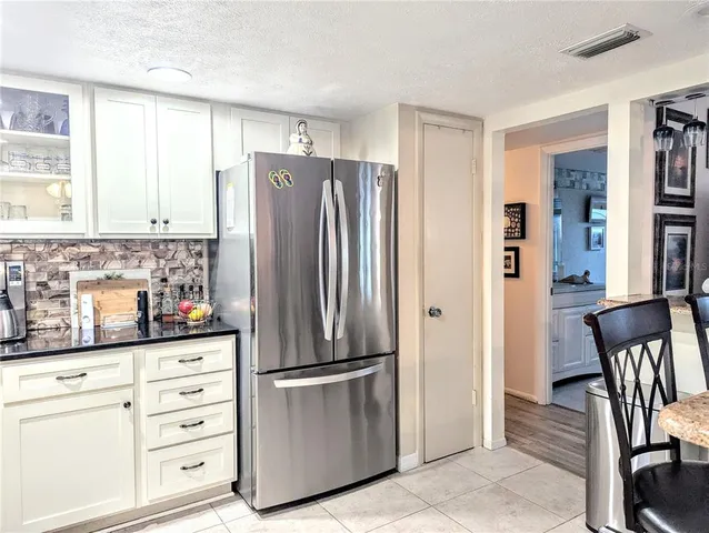 a kitchen with stainless steel appliances a refrigerator sink and cabinets