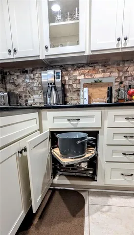 a stove top oven sitting inside of a kitchen and sink