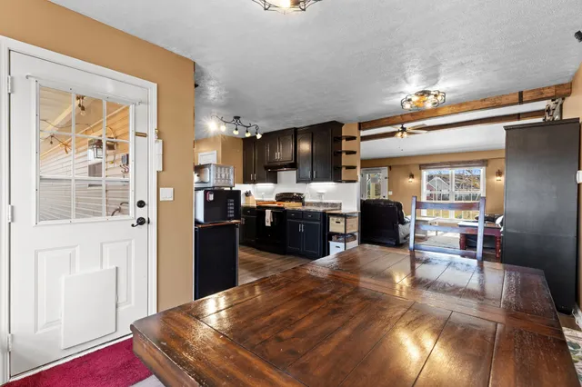 a kitchen with stainless steel appliances kitchen island granite countertop a refrigerator and stove