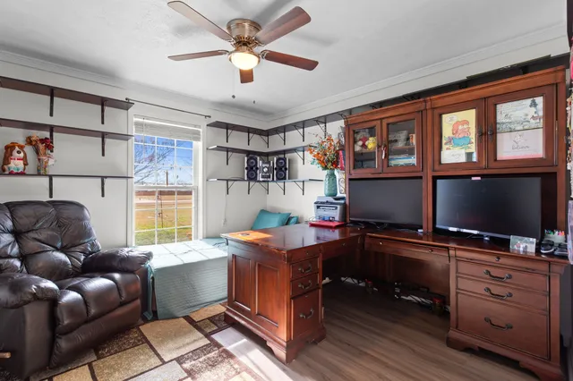 a work room with furniture and a flat screen tv