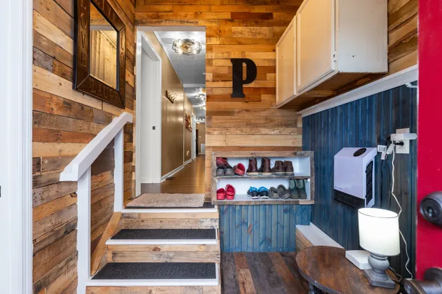 a view of entryway and hall with wooden floor