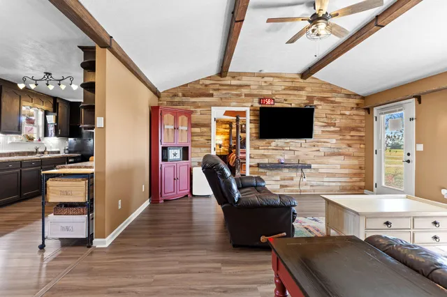 a view of a livingroom with furniture and a flat screen tv