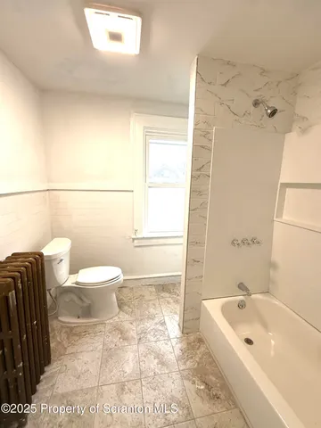 a bathroom with a toilet a sink and bathtub