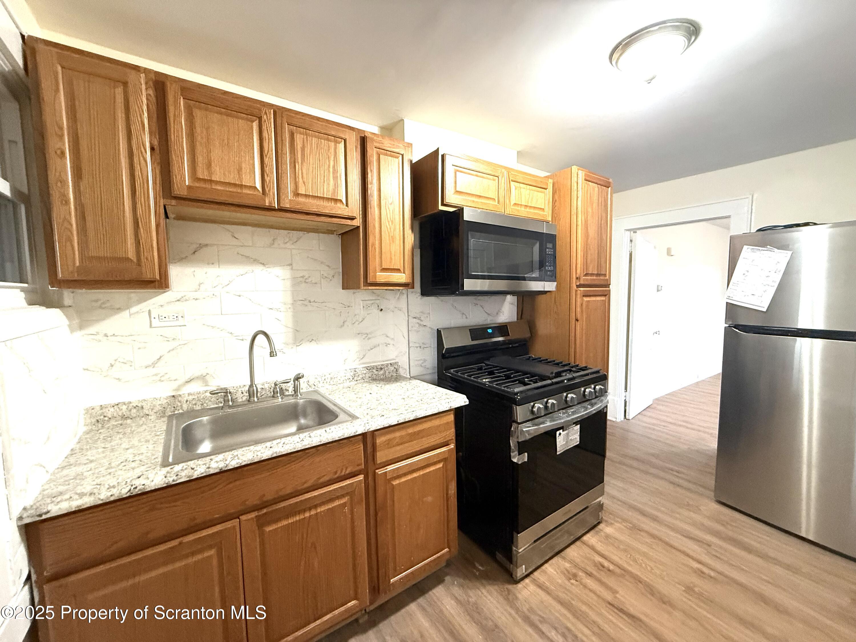 37 Shea Street, Unit 2 Nanticoke, PA 18634 - Photo 7 of 24 a kitchen with a sink stove and refrigerator