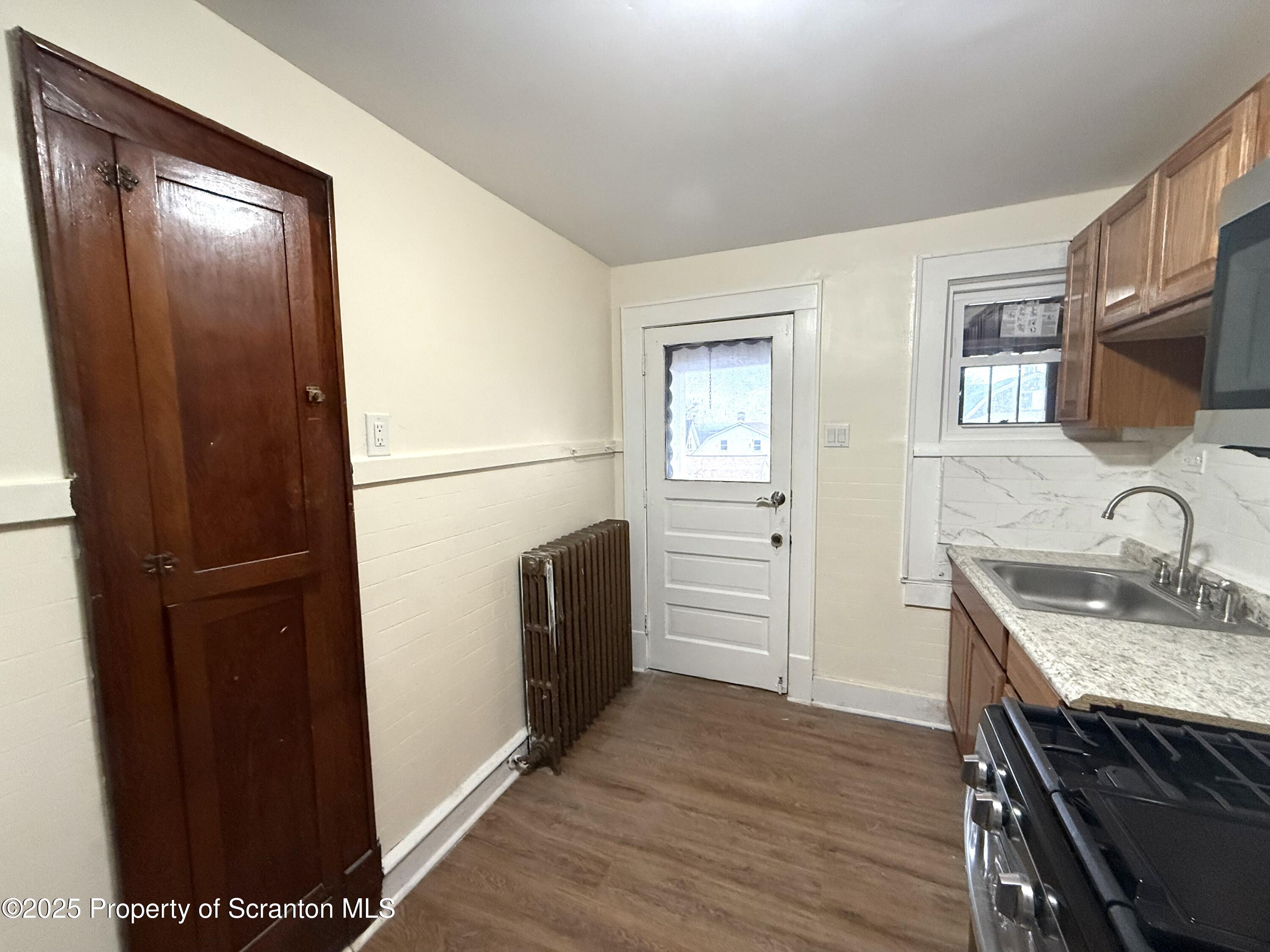 37 Shea Street, Unit 2 Nanticoke, PA 18634 - Photo 9 of 24 a kitchen with a refrigerator and a sink