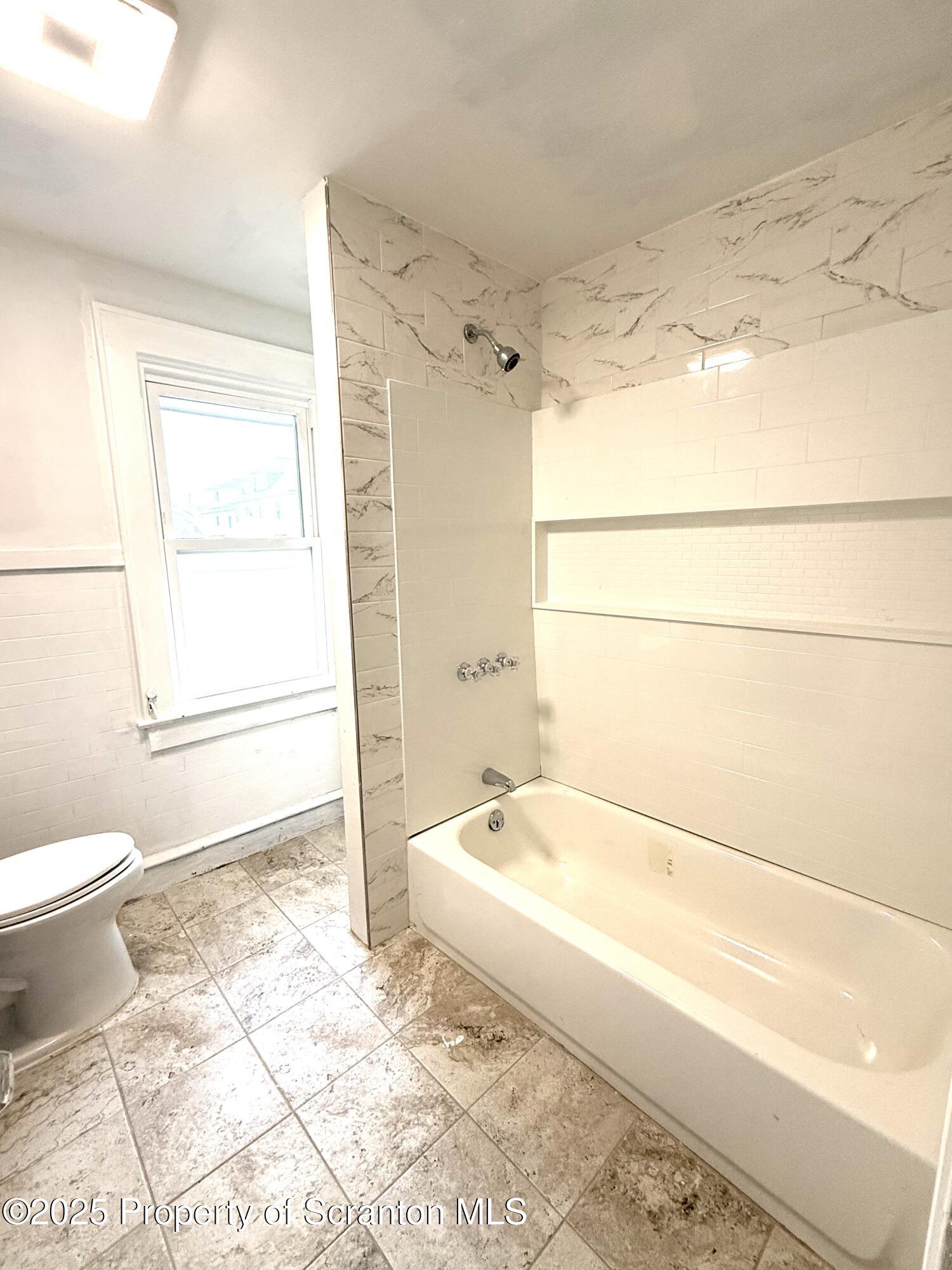 37 Shea Street, Unit 2 Nanticoke, PA 18634 - Photo 10 of 24 a bathroom with a bathtub and a toilet