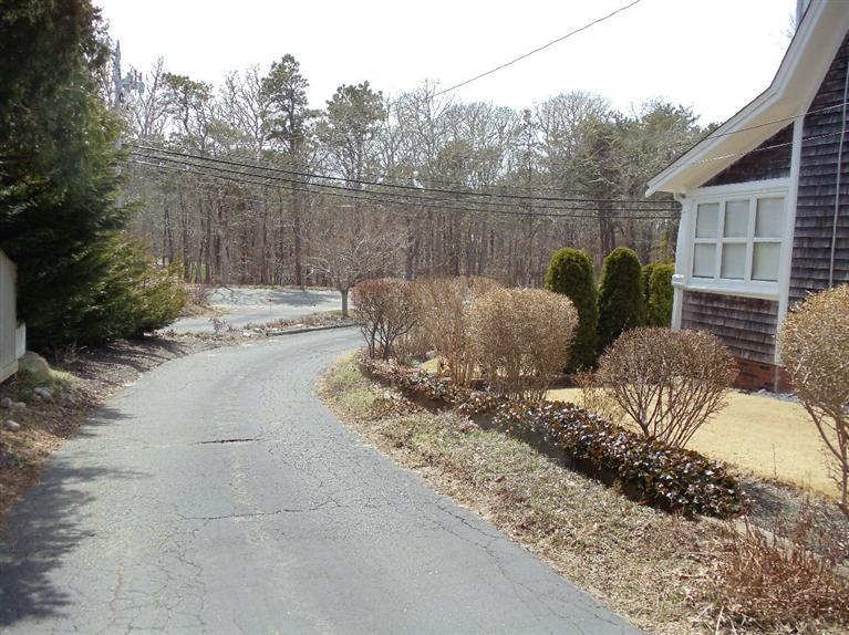 174 Chatham Road Harwich, MA 02645 - Photo 3 of 33 a view of a lake with couches and wooden fence