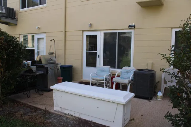 a view of a patio with couches table and chairs and potted plants