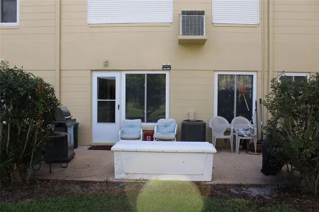 a view of a patio with couches table and chairs and potted plants