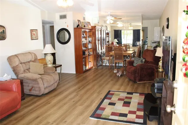 a living room with furniture a rug and white walls