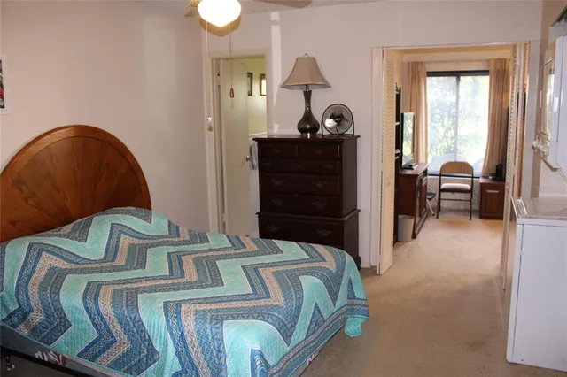 a bedroom with a bed and dresser with mirror