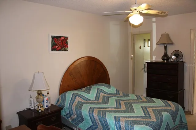 a bedroom with a bed and dresser with mirror