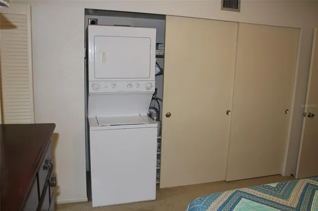a view of walk in closet with empty racks