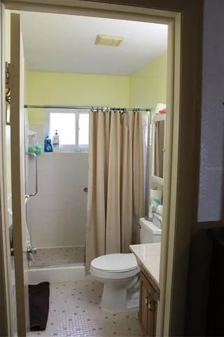 a bathroom with a toilet a sink and shower