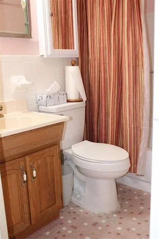 a bathroom with a sink a toilet and vanity