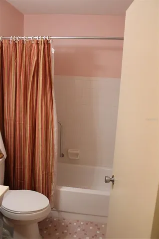 a bathroom with a shower and a toilet