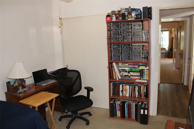 a livingroom with a book shelf and a book shelf