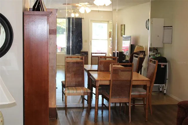 a view of a dining room with furniture and window