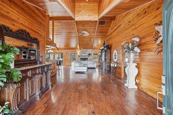 a living room with furniture a fireplace and wooden floor
