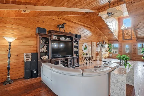 a kitchen with stainless steel appliances granite countertop a table and chairs in it