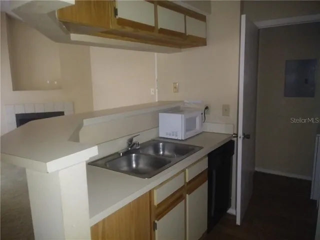 a kitchen with a sink and cabinets