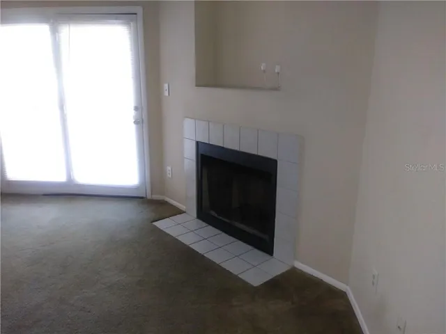 a view of empty room with a fireplace