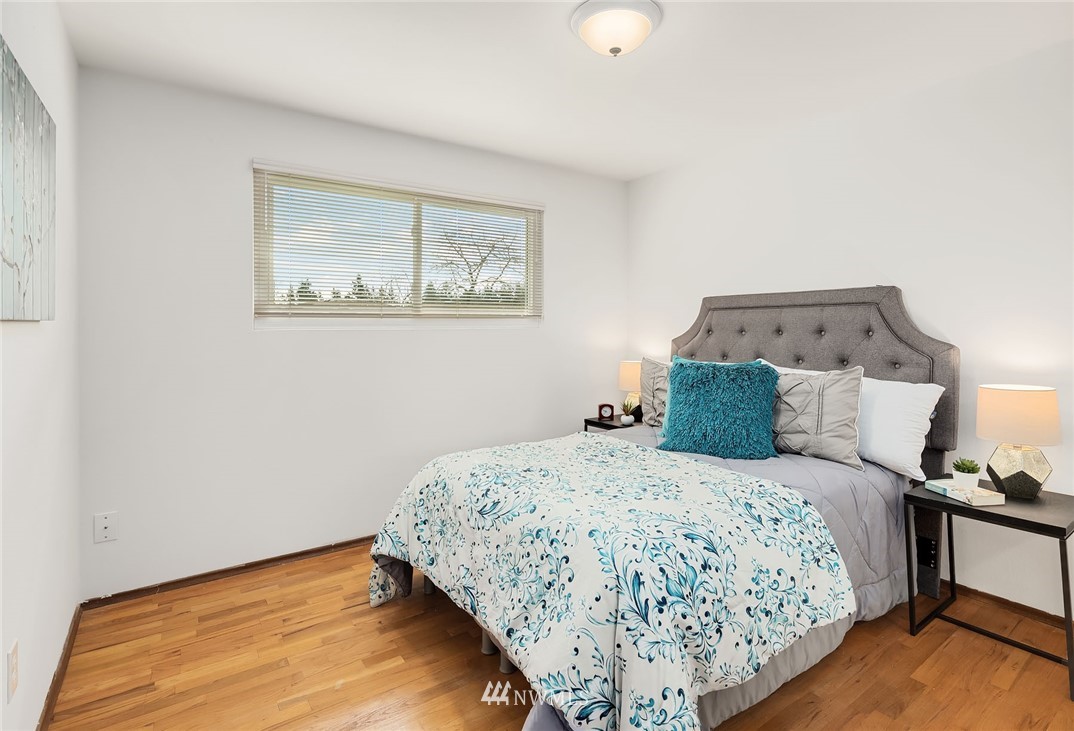 6611 Southeast 5th Place Renton, WA 98059 - Photo 13 of 25 a bedroom with a bed and wooden floor