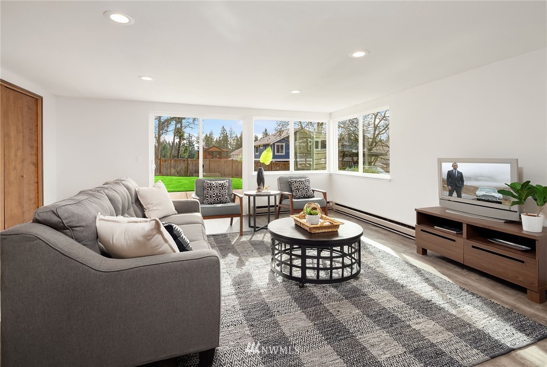 6611 Southeast 5th Place Renton, WA 98059 - Photo 16 of 25 a living room with furniture and a floor to ceiling window