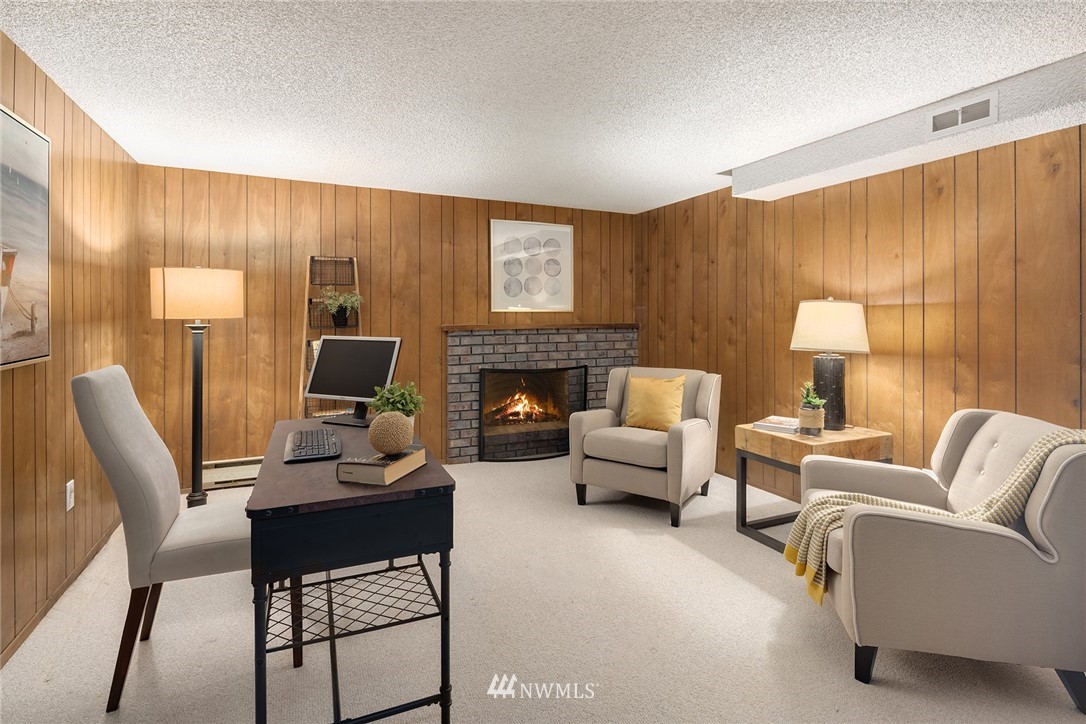 6611 Southeast 5th Place Renton, WA 98059 - Photo 18 of 25 a living room with furniture a fireplace and a large window