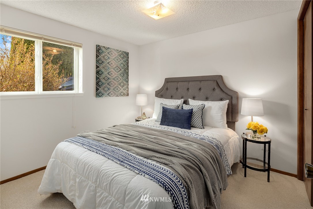 6611 Southeast 5th Place Renton, WA 98059 - Photo 19 of 25 a bedroom with a bed and window