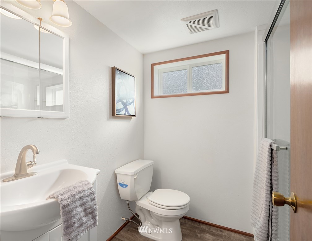 6611 Southeast 5th Place Renton, WA 98059 - Photo 20 of 25 a bathroom with a sink toilet and a mirror