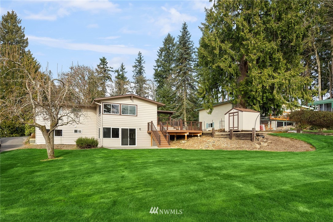6611 Southeast 5th Place Renton, WA 98059 - Photo 25 of 25 a front view of a house with garden and trees