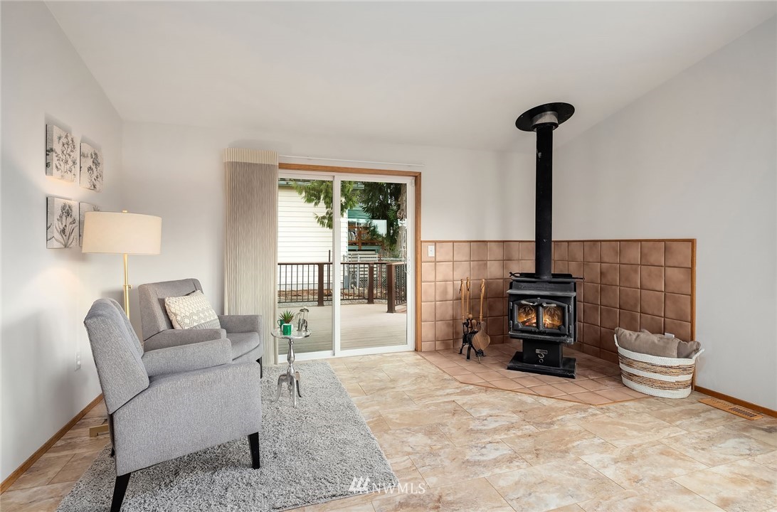 6611 Southeast 5th Place Renton, WA 98059 - Photo 7 of 25 a living room with furniture a fireplace and a table
