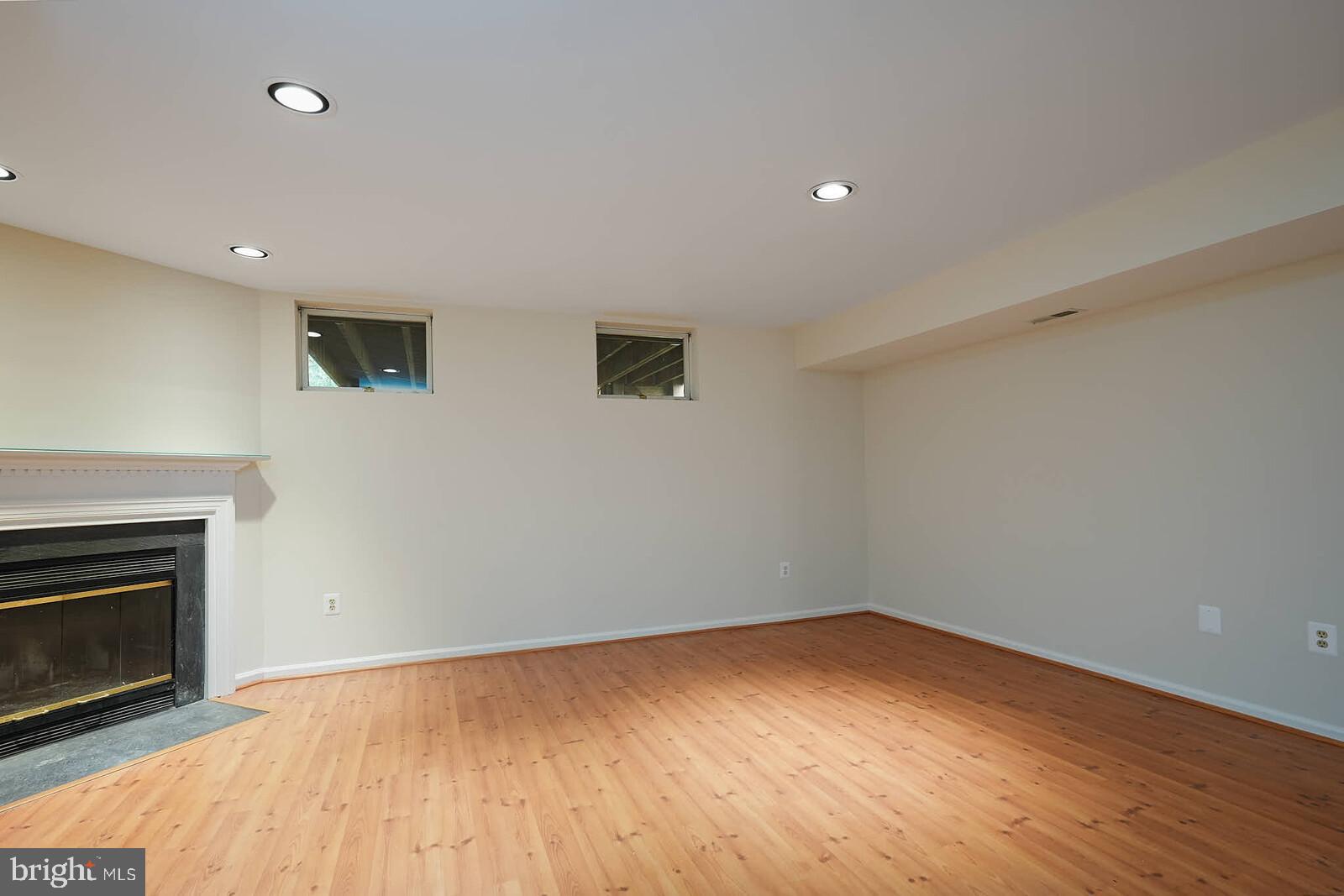9303 Kendal Circle Laurel, MD 20723 - Photo 34 of 50 a view of empty room with wooden floor and fireplace