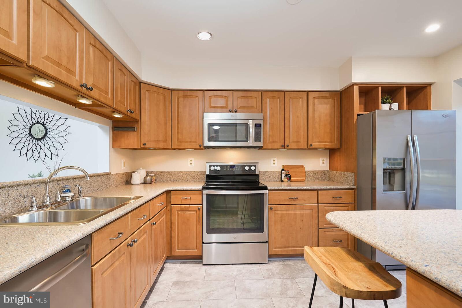 9303 Kendal Circle Laurel, MD 20723 - Photo 4 of 50 a kitchen with stainless steel appliances granite countertop a sink stove and refrigerator