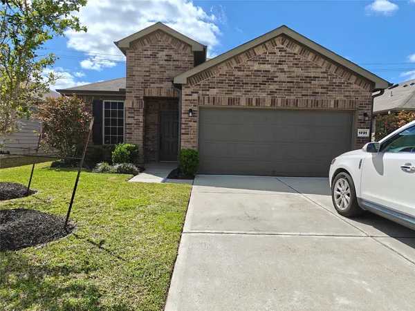 a view of a car parked front of a house