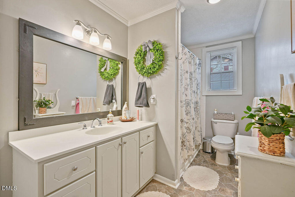 305 South 17th Street Erwin, NC 28339 - Photo 11 of 35 a bathroom with a sink toilet and a mirror