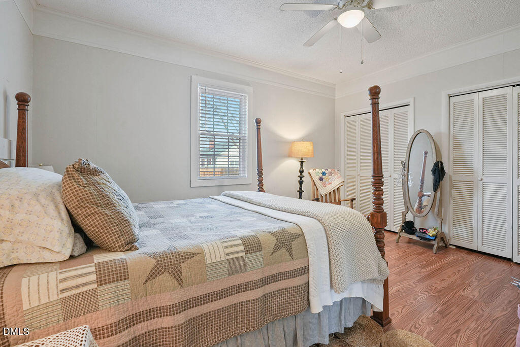 305 South 17th Street Erwin, NC 28339 - Photo 12 of 35 a bedroom with bed and a chandelier