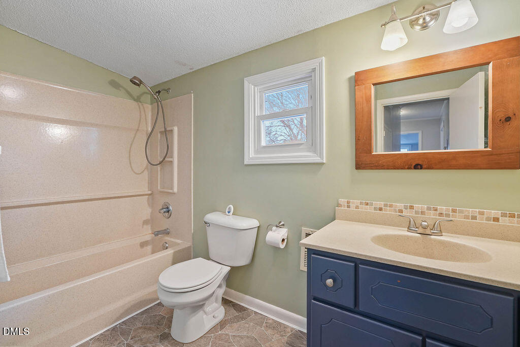 305 South 17th Street Erwin, NC 28339 - Photo 20 of 35 a bathroom with a sink toilet and shower
