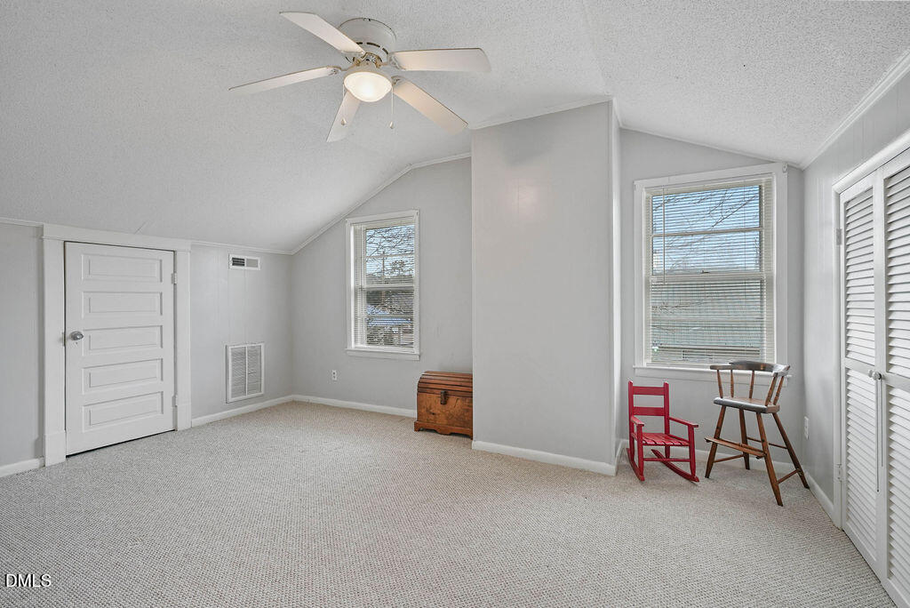 305 South 17th Street Erwin, NC 28339 - Photo 23 of 35 an empty room with windows and ceiling fan view