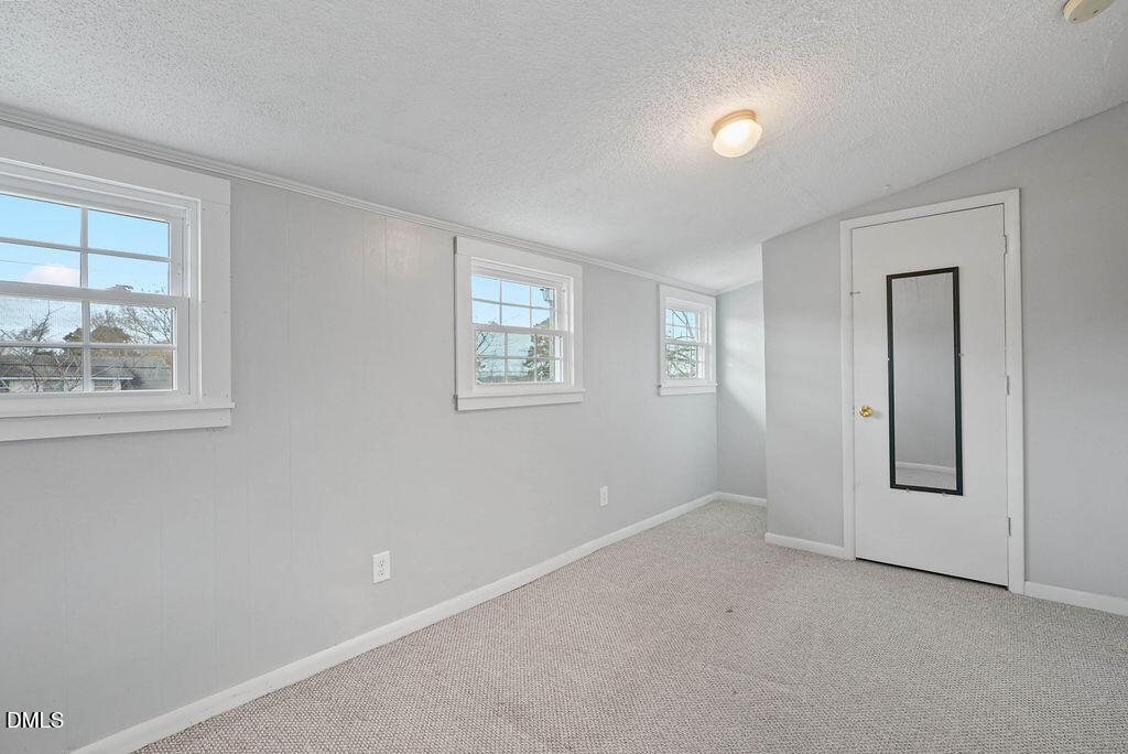 305 South 17th Street Erwin, NC 28339 - Photo 25 of 35 an empty room with windows and closet