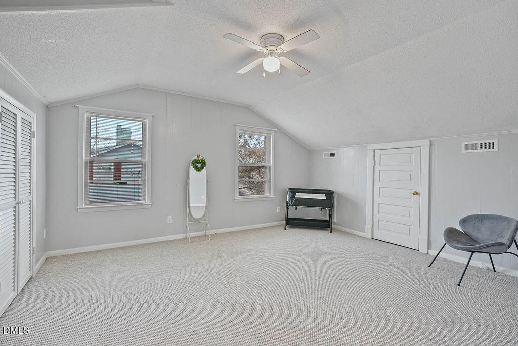 305 South 17th Street Erwin, NC 28339 - Photo 27 of 35 an empty room with windows and ceiling fan