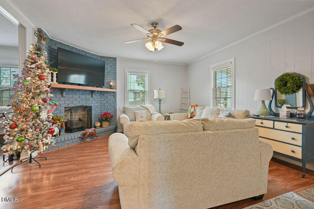 305 South 17th Street Erwin, NC 28339 - Photo 7 of 35 a living room with furniture a fireplace and a large window