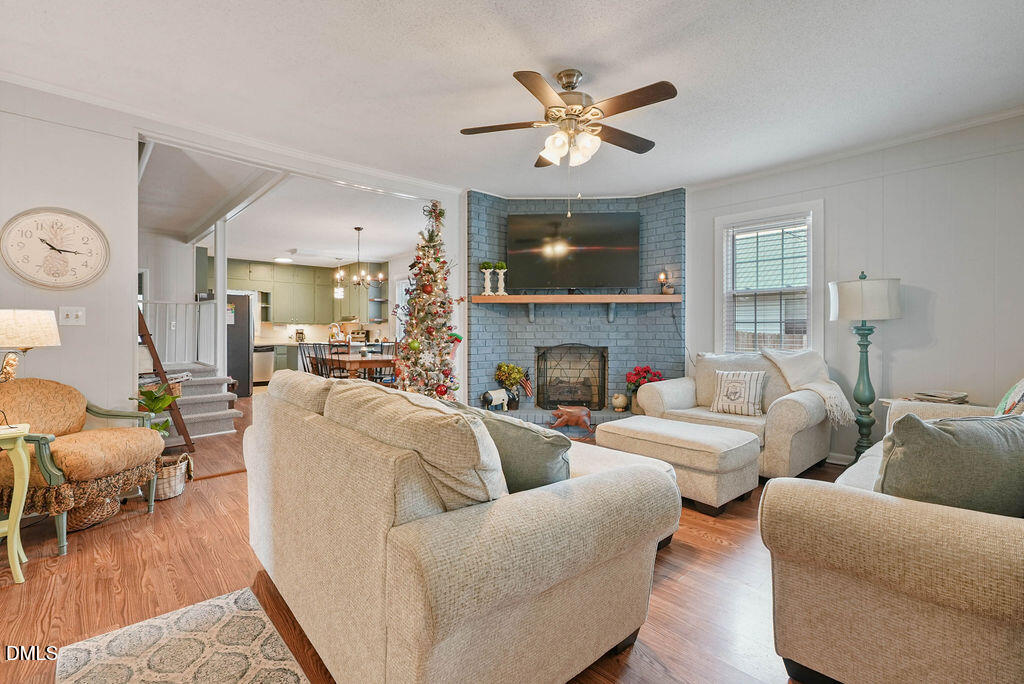 305 South 17th Street Erwin, NC 28339 - Photo 8 of 35 a living room with furniture a fireplace and a flat screen tv