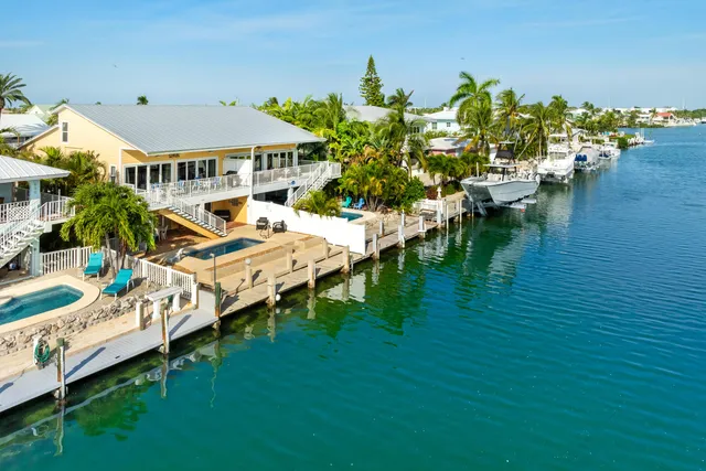a living room with furniture a flat screen tv and a floor to ceiling window